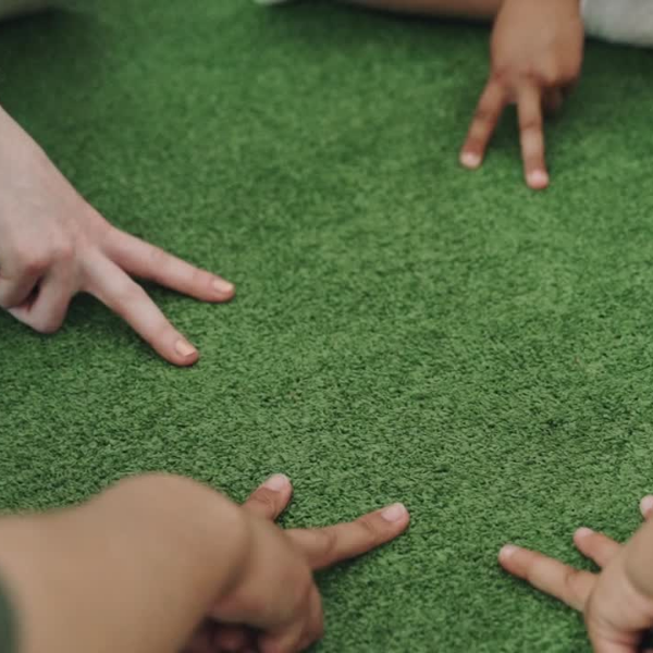 Close-up of the hands of children of different races, making the victory pose